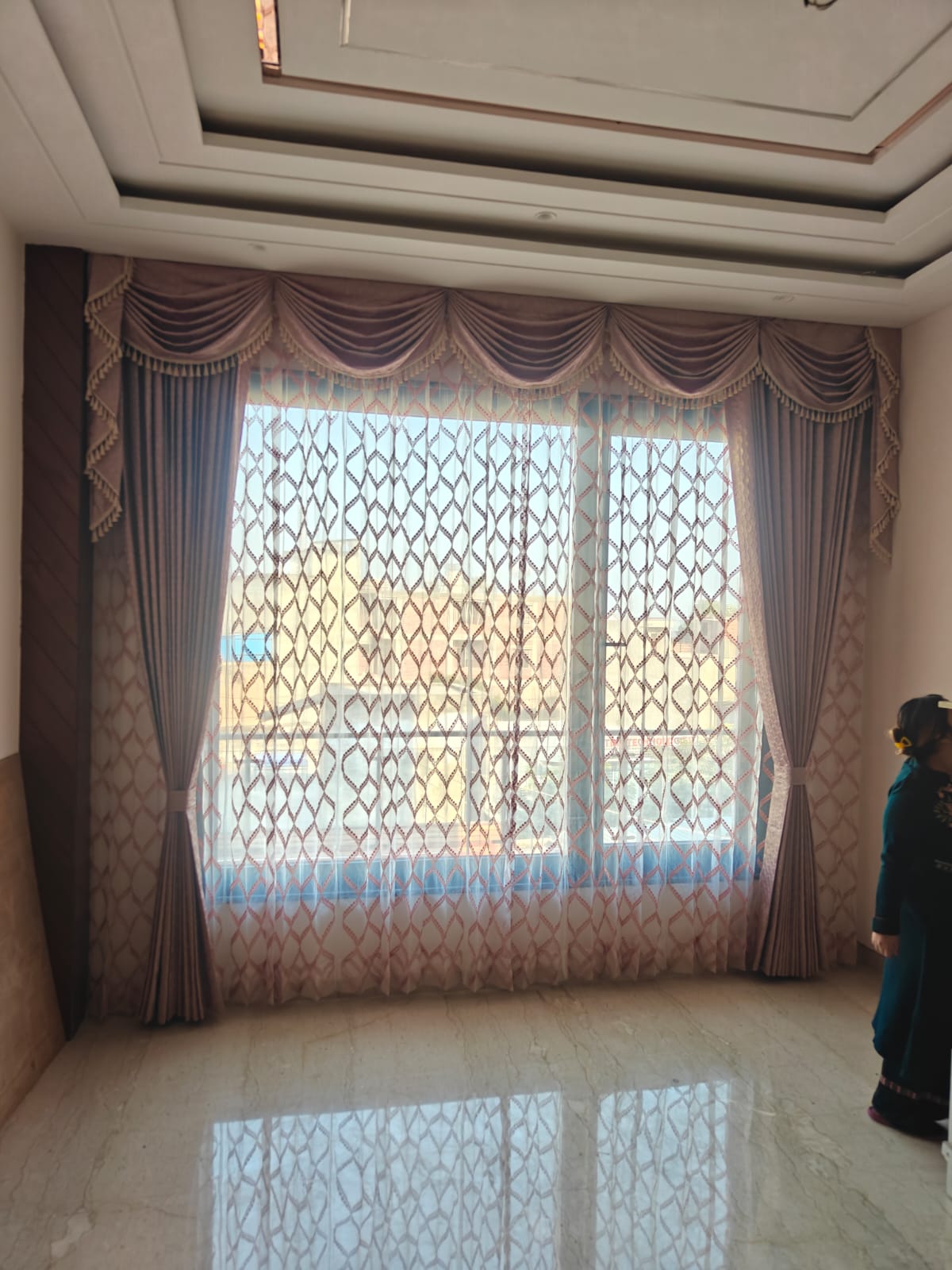 Premium rose gold pleated drapery with classic swag valances and a geometric pattern net sheer curtain