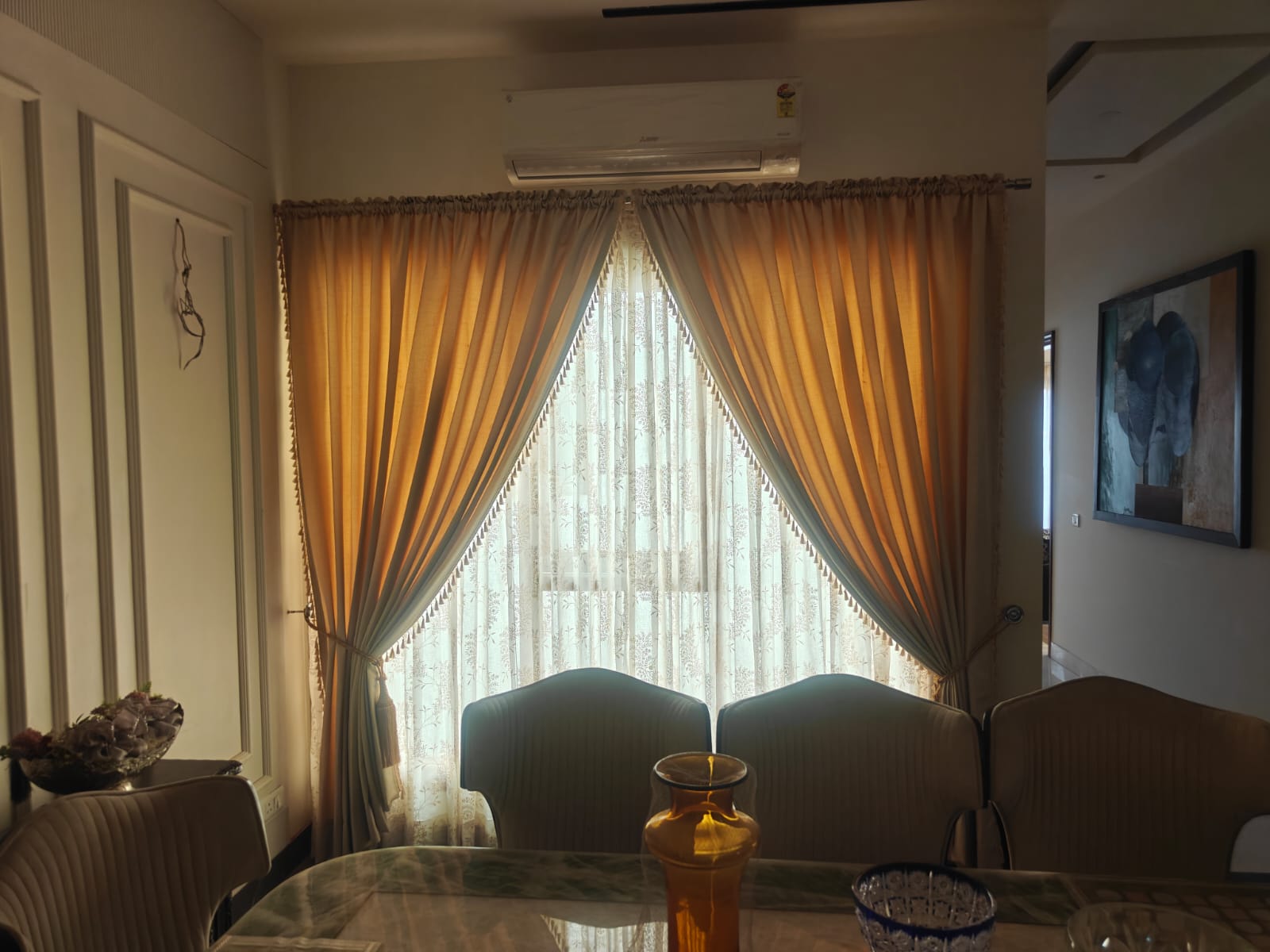 Rich mustard gold window curtains with decorative edge fringe details paired with classic embroidered cream sheer curtains
